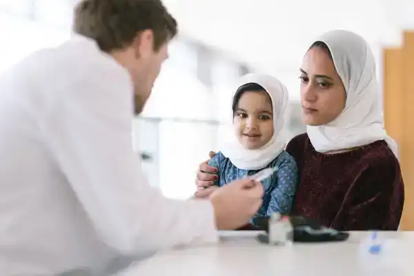 mother and daughter talking to doctor about height growth hormone
