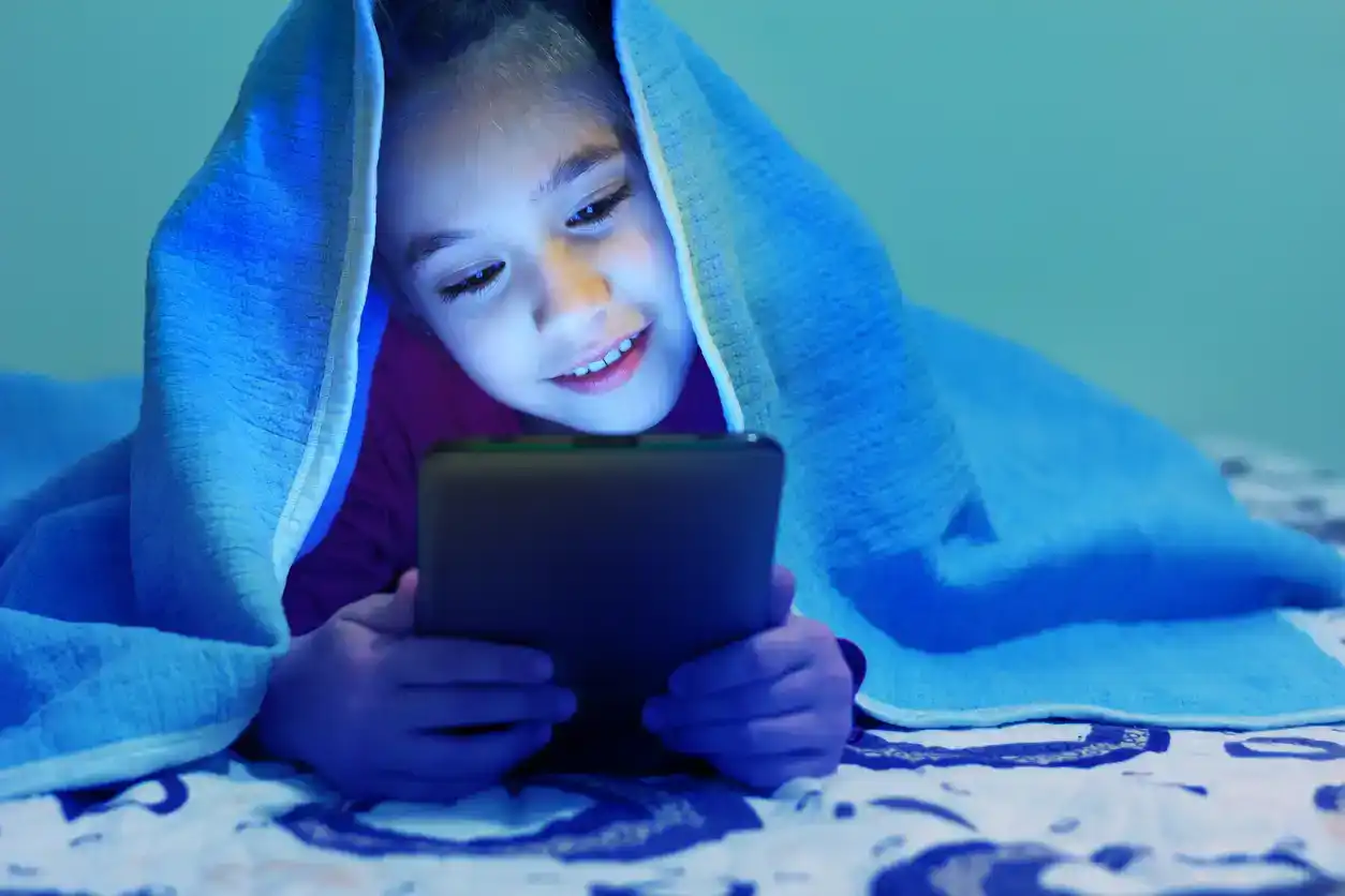 Little girl using tablet at home