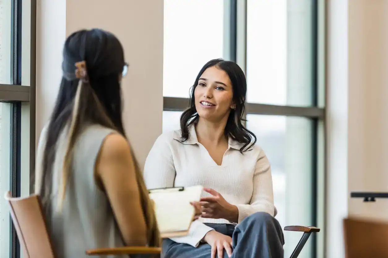 A young mother speaks to therapist to help cope with and manager triggers from her traumatic childhood. Concept of breaking generational trauma.
