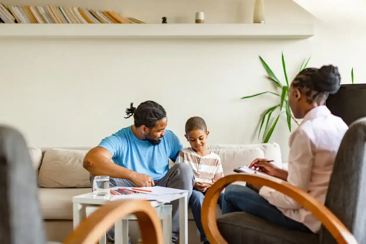 Father and son attend Child-Parent Psychotherapy (CCP) session. Concept of breaking generational trauma and building a healthy, happy family.