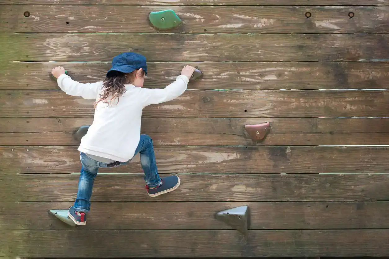 little girl rock climbing