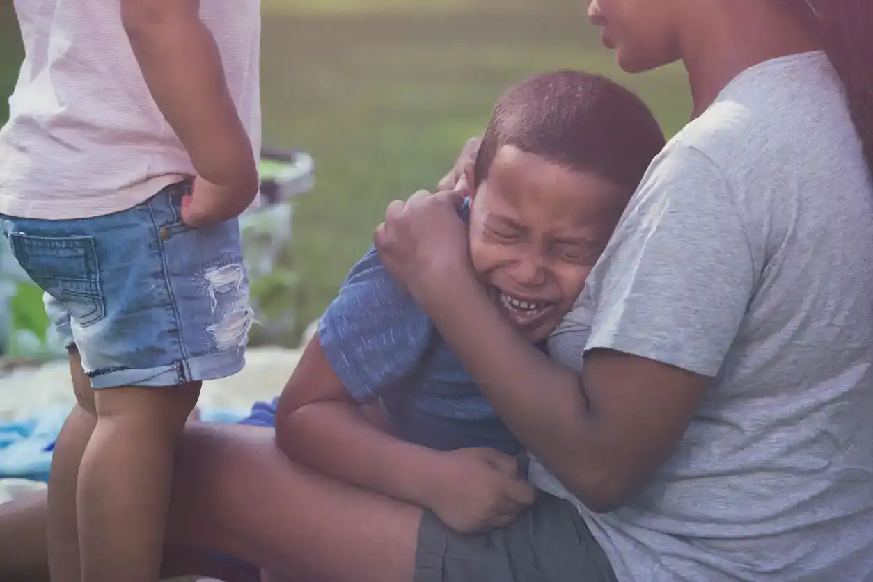 mom consoling boy crying