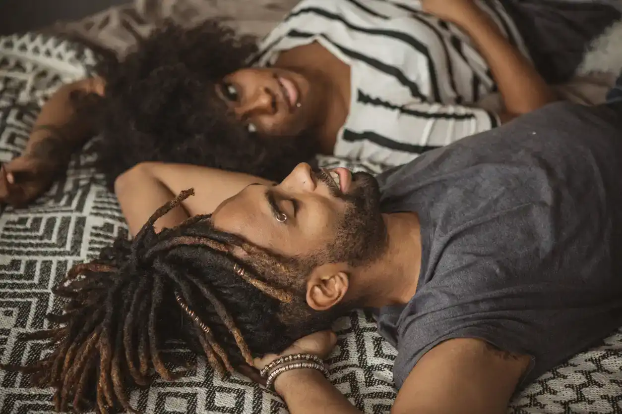 married couple having conversation in bed