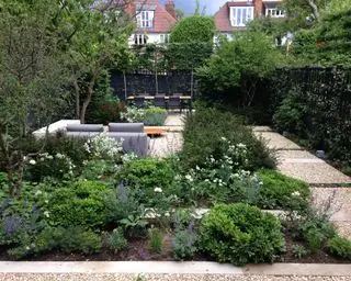 jardim voltado para o norte com áreas separadas para entretenimento por Charlotte Rowe