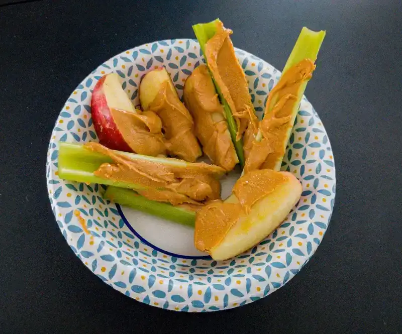Celery apples and peanut butter stock photo