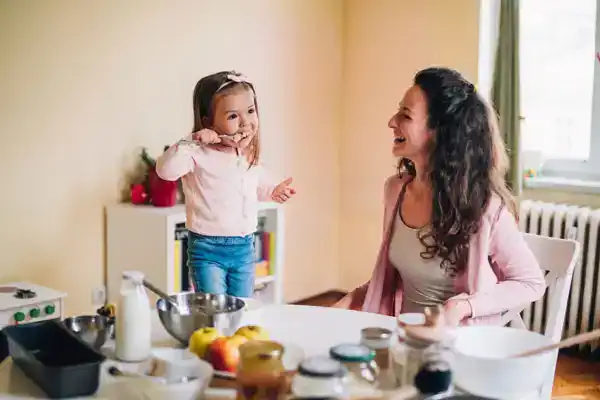 mom and toddler daughter laughing together