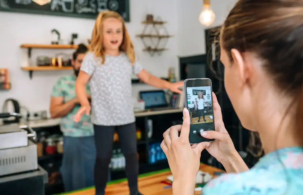 Mother films daughter on her iPhone