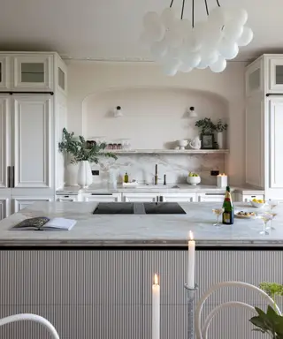 Uma cozinha branca com armários detalhados