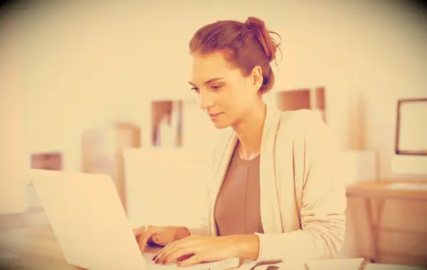 A woman working hard at her laptop.