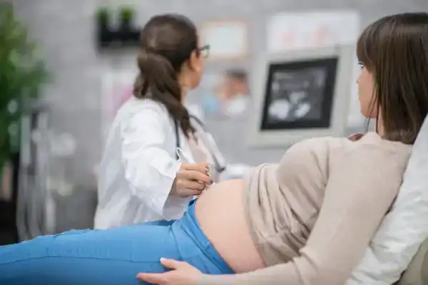 Doctor doing ultrasound tand down syndrome screen on pregnant lady