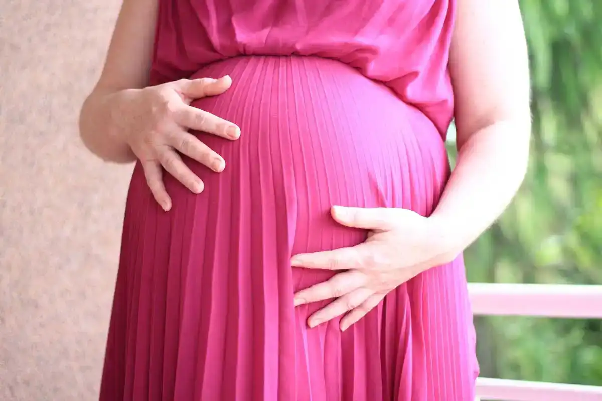 pregnant woman sitting in window