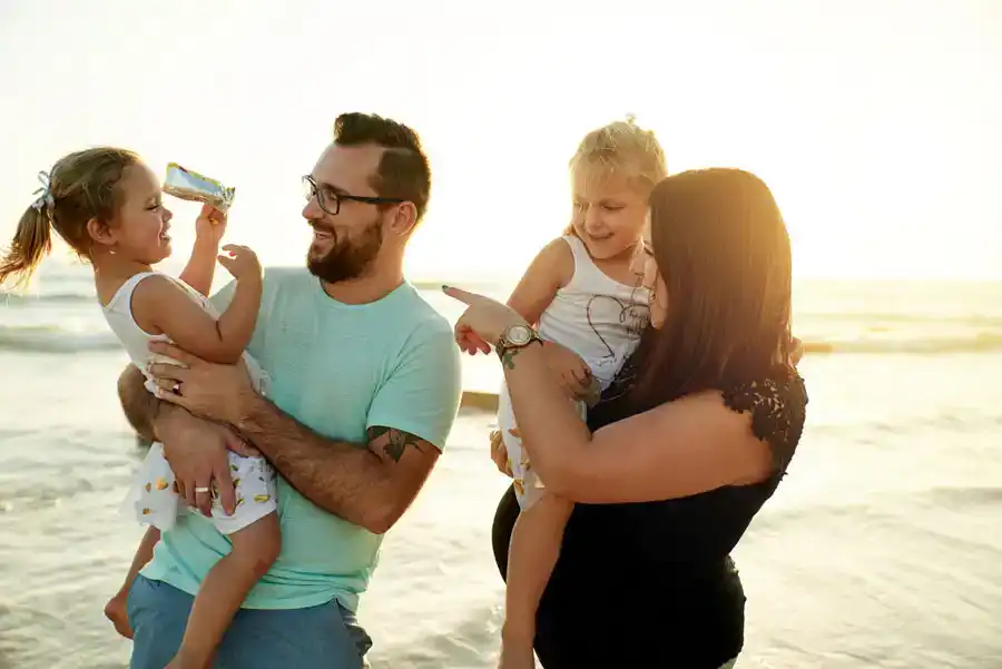Pregnant mom with her family on the beach