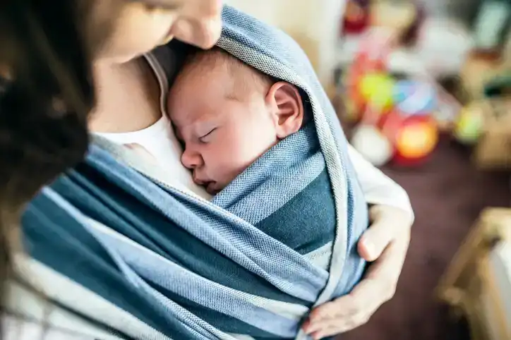 baby in blue wrap
