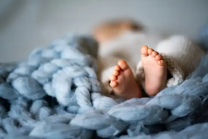baby in blue wrap
