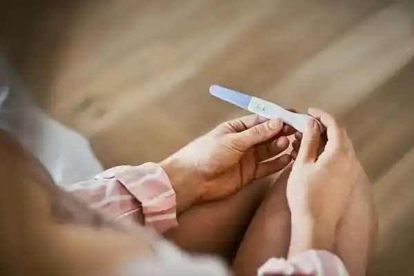 woman looking at pregnancy test