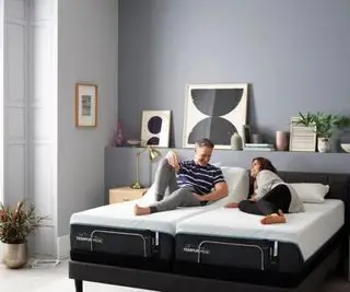 Un homme et une femme allongés sur le matelas Tempur-Pedic ProAdapt.