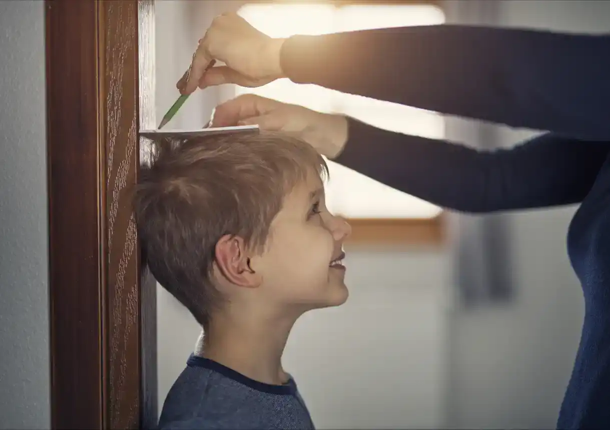 Mother measuring son