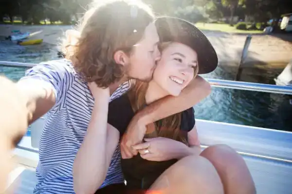 teen couple taking selfie