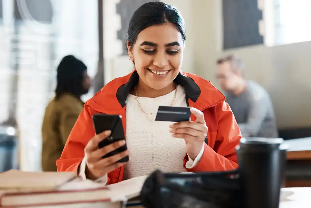 Teenage girl student uses her credit card