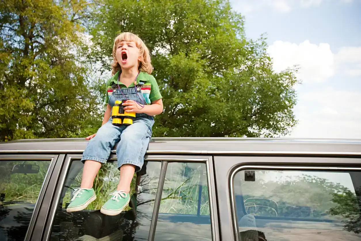 young boy throws temper tantrum. Screaming on top of mom