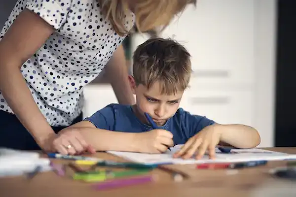 Helicopter parent hovering over child doing homework