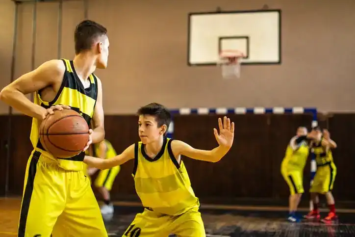 Teenage basketball team plating friendly match at indoors basketball court stock photo