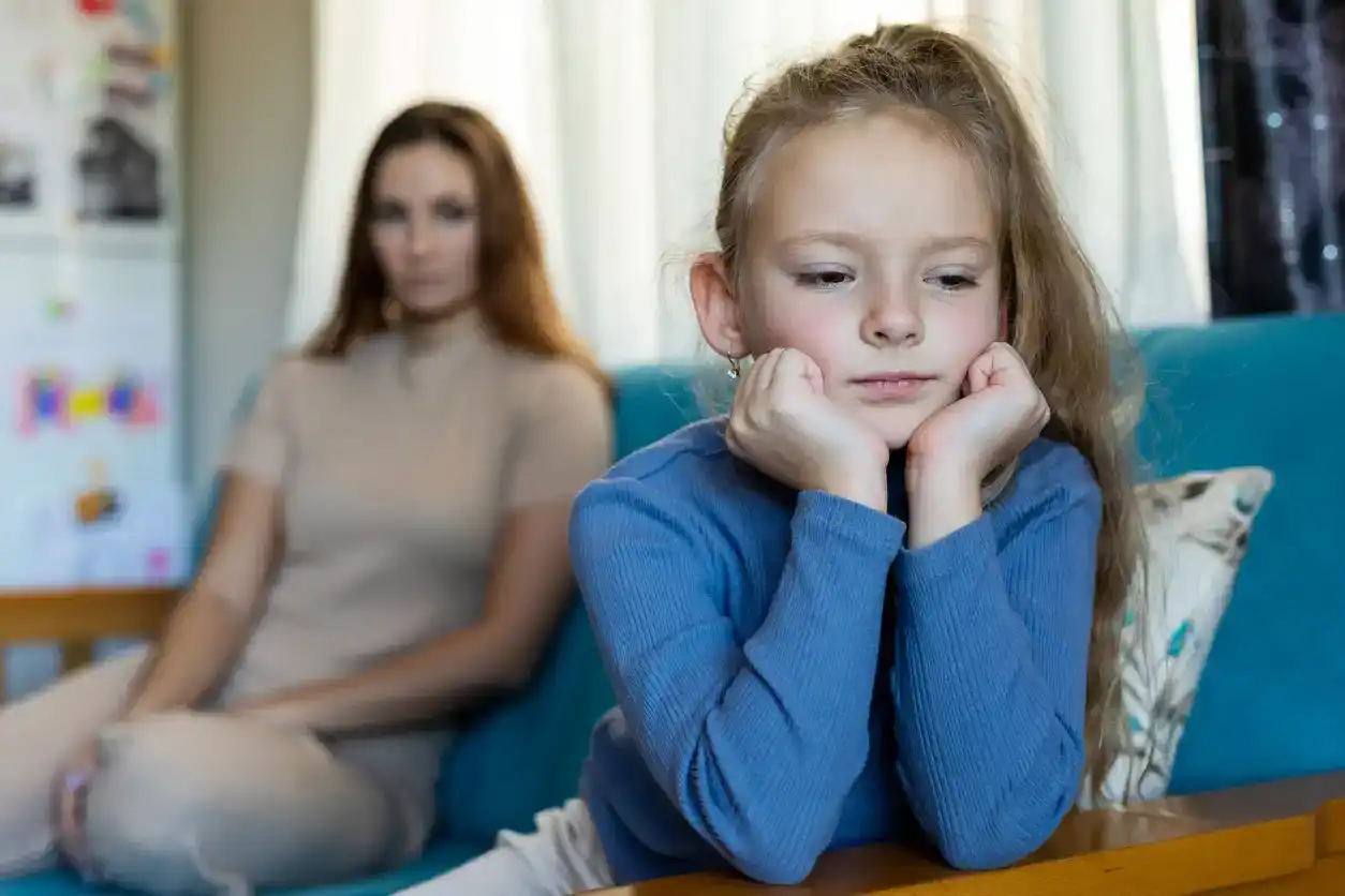 Young girl being reprimanded by her mother at home
