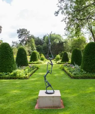 escultura figurativa de jardín en un área de jardín formal