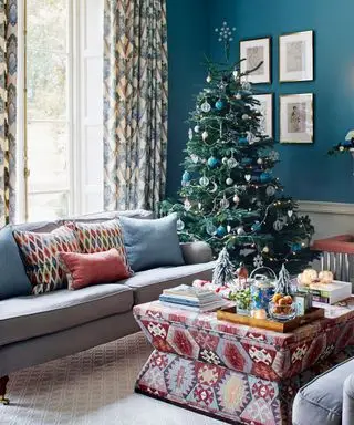 Blaues Wohnzimmer mit Weihnachtsbaum und Sofa