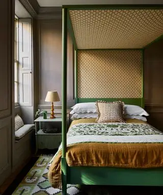 Cama con dosel pintada de verde y tela con dosel amarillo