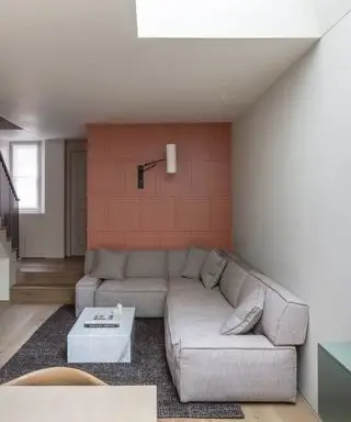 murs d'accent, mur d'accent à panneaux de corail avec applique murale, section grise, tapis texturé, table basse en marbre