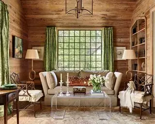 Cabina con paneles de madera, cortinas verdes y decoración campestre francesa