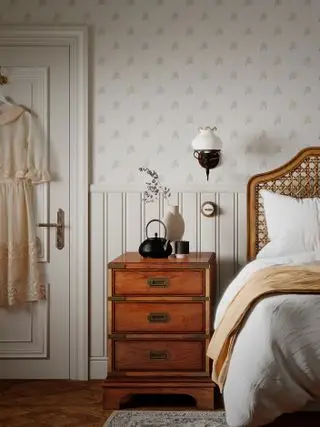 nøytralt soverom med diskret tapet, rottingseng, vintage sidebord, vegglampe