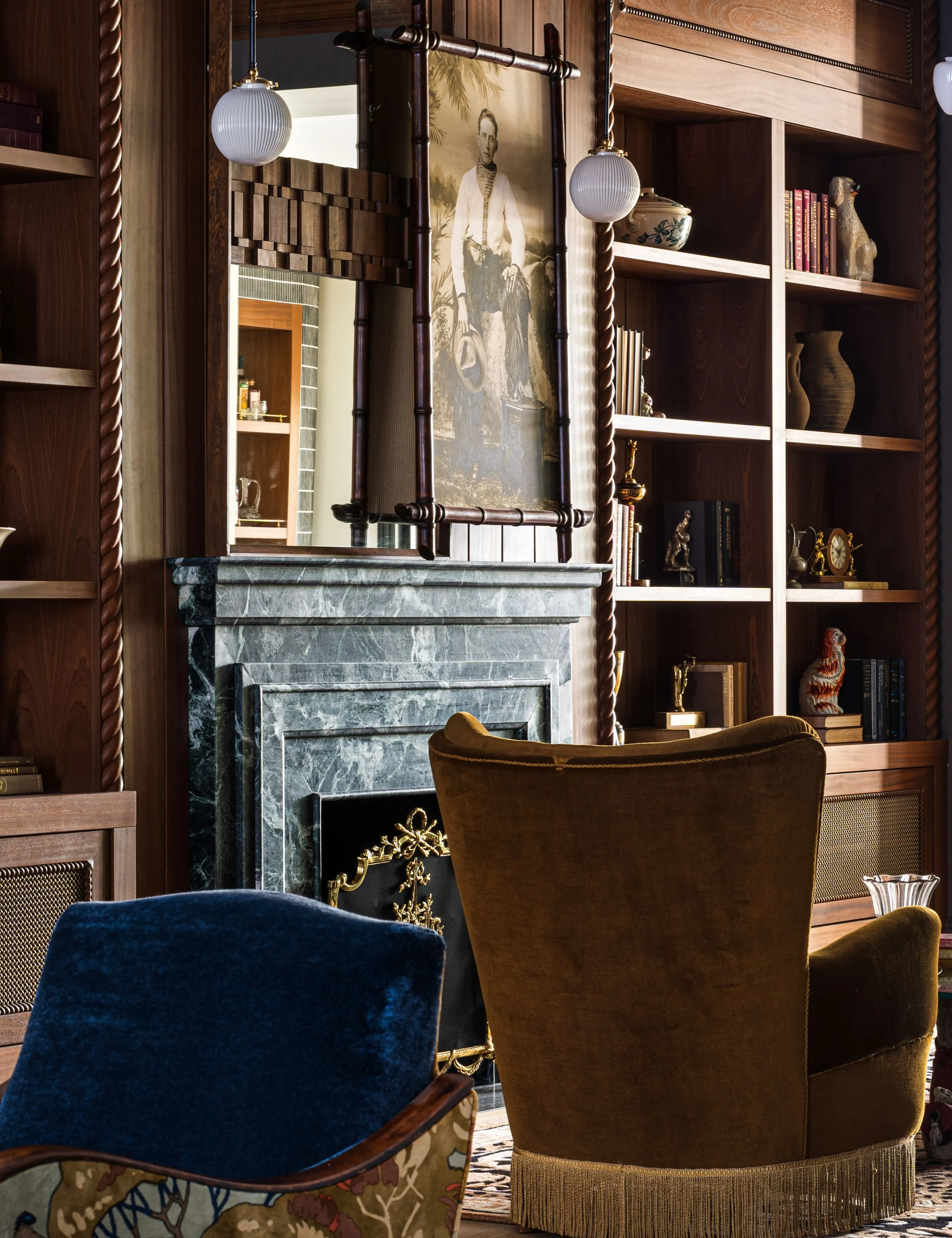 NYC salon rum med varmt træ mølleværk mælk glas vedhæng belysning frynsede accent stole og en slående grøn marmor pejs' loading='lazy' title=