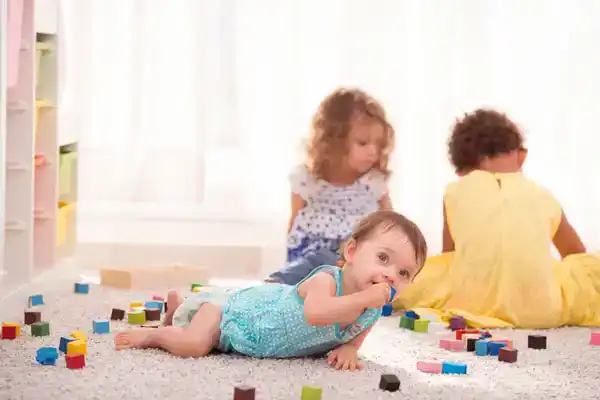 baby putting plastic in mouth