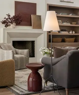 Gemütliches Wohnzimmer mit Tischlampe, Sitzgelegenheit und Kamin