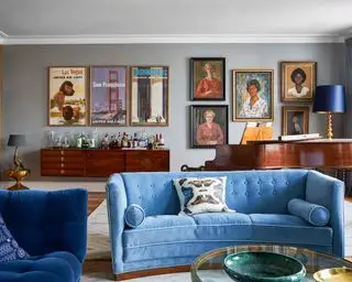 salon neutre avec canapé en velours bleu et murs gris
