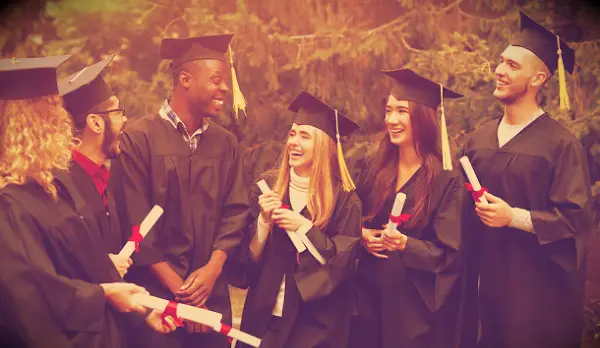 Happy graduating students laughing after their ceremony.