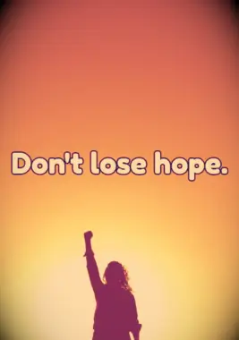 A woman with her fist raised and not losing hope.