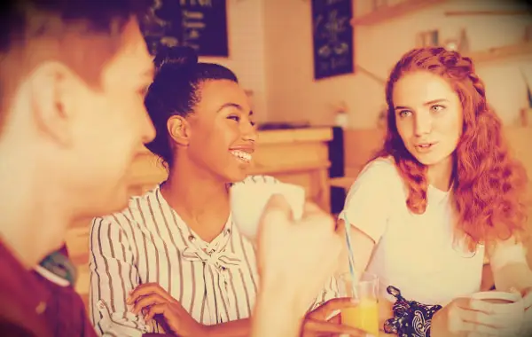 Friends laughing and having fun in a cafe.
