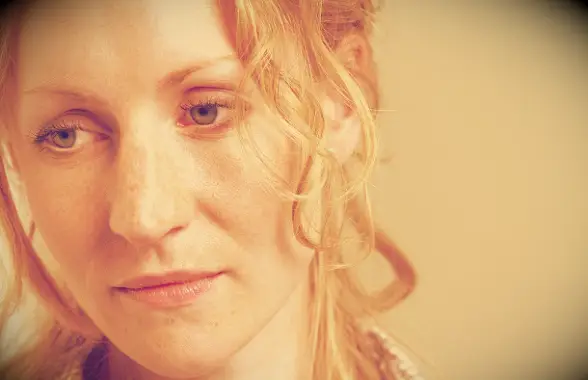 A woman looking thoughtful and a little bit sad.