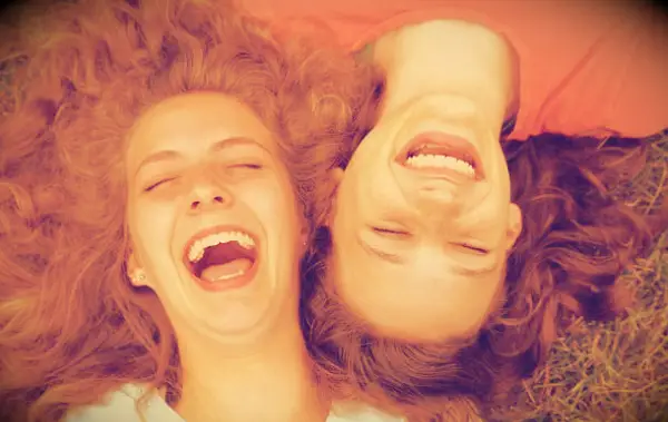 Two friends laughing together.