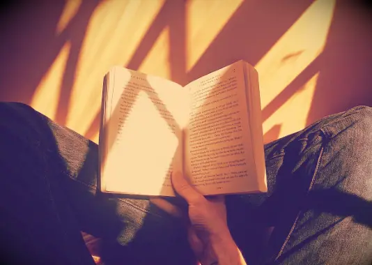 An image of a person reading a book.