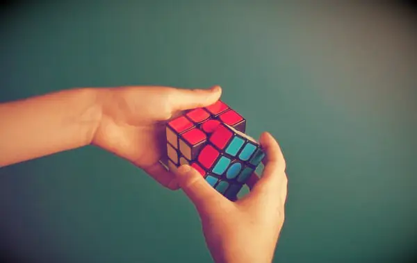 An image of a person solving a Rubicks cube.