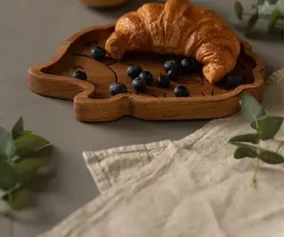 Un tovagliolo accanto a un piatto e un croissant