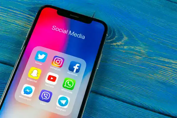 iPhone sitting on blue table with snapchat app on display