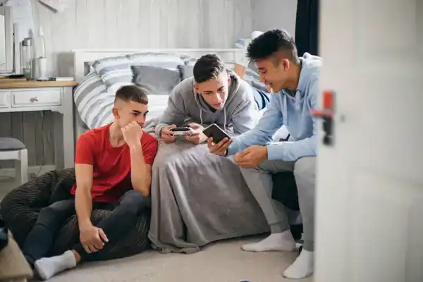 Teenage boys looking at Snapchat app on friend